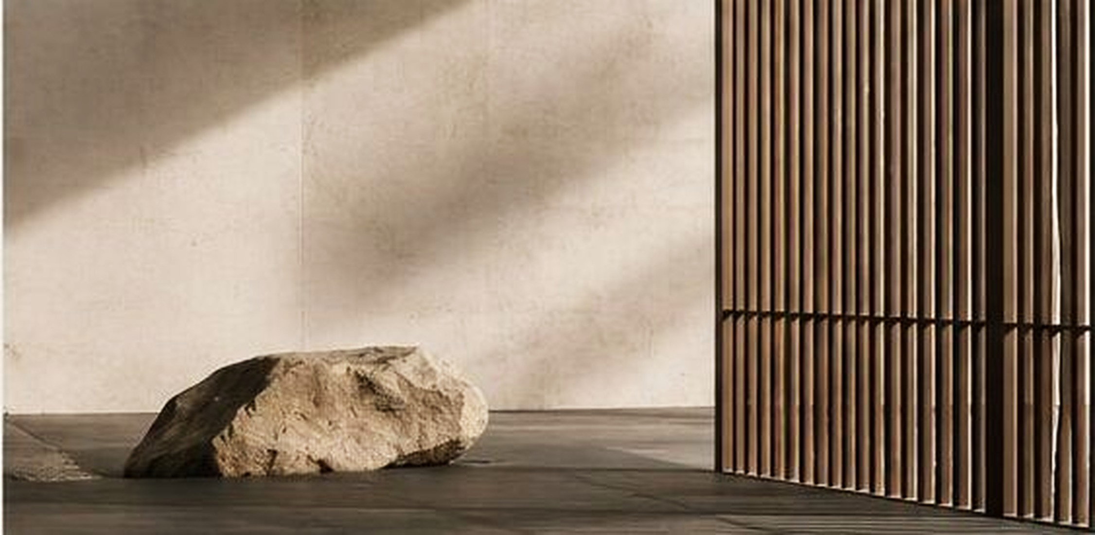 Stone element against a textured wall and slatted screen